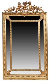 French Gilt and Gesso Louis XVI Style Overmantel Cushion Mirror, 19th c., the pierced putti, leaf and floral carved crest over a relief frame and thre