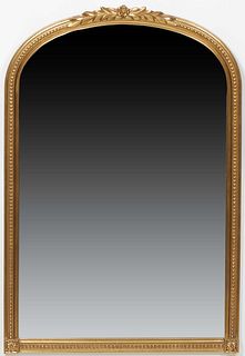 French Louis XVI Style Gilt and Gesso Overmantel Mirror, 20th c., the floral carved relief leaf and floral arched top over a beaded frame with a round