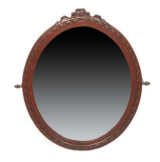 French Louis XVI Style Carved Walnut Overmantel Mirror, early 20th c., the oval twist carved frame with a floral crest, around an oval wide beveled mi