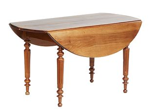 French Provincial Louis Philippe Carved Walnut Drop Leaf Table, 19th c., the oval top over a wide skirt, on turned tapered reeded legs with toupie fee