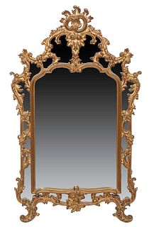 French Louis XV Style Gilt and Gesso Overmantel Mirror, 20th c., the arched shell and floral crest over an arched mirror plate, flanked by a relief fl