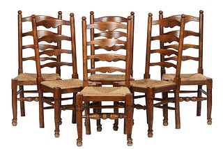 Set of Six French Provincial Carved Oak Ladderback Rushseat Dining Chairs, early 20th c., the canted ladderbacks over trapezoidal rushseats, on turned