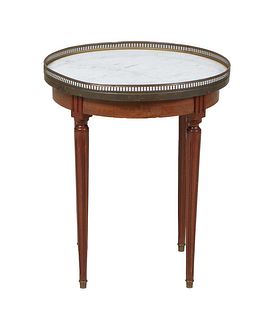 French Louis XVI Style Carved Walnut Marble Top Gueridon, 20th c., the brass galleried figured white marble over a reeded skirt, on turned tapered ree