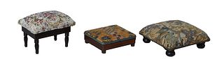 Group of Three French Carved Walnut Footstools, 19th c., one with floral needlepoint upholstery with iron tack decoration on turned legs, H.- 5 3/4 in