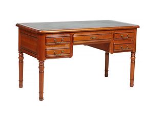French Louis XVI Style Carved Cherry Desk, 20th c., the stepped rounded corner top with an inlaid gilt toiled green leather writing surface over a set