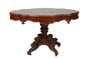 French Carved Walnut Louis Philippe Marble Top Center Table, circa 1860, the highly figured inset grey marble over a wide scalloped skirt with a friez