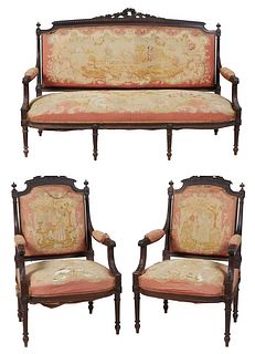 French Carved Walnut Louis XVI Style Three Piece Parlor Suite, 19th c., consisting of a settee and a pair of fauteuils, the floral and leaf carved wre