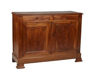 French Louis Philippe Carved Walnut Sideboard, 19th c., the stepped rounded edge top over two frieze drawers above double cupboard doors, on ogee bloc
