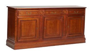 French Louis XVI Style Carved Cherry Sideboard, 20th c., the ogee edge canted corner top over three setback frieze drawers above three fielded panel c