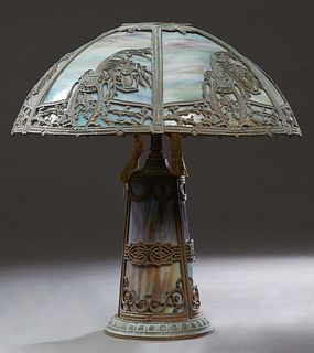 American Spelter Slag Glass Lamp, probably Edward Miller, the curved six panel purple shade with floral and eagle cutouts, on a sloping lighted purple