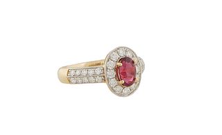 Lady's 18K Yellow Gold Dinner Ring, with an oval 1.06 ct. ruby atop a conforming border of round diamonds, the shoulders of the band mounted with doub