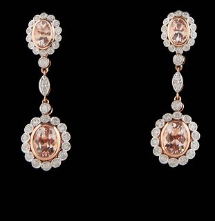 Pair of 14K Rose Gold Pendant Earrings, each stud with an oval morganite within a border of round diamonds, suspending diamond mounted chains to a lik