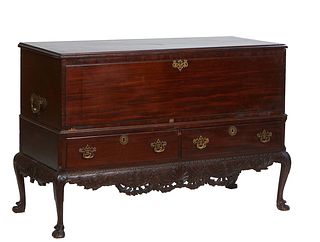 English Carved Mahogany Chippendale Style Bedding Box, early 19th c., the ogee edge rounding corner lid over open storage and two deep drawers, on cab