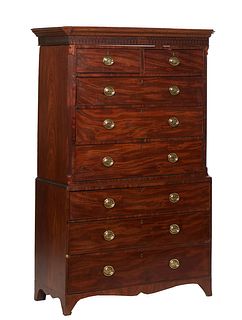 English Carved Mahogany Chest-on-Chest, 19th c., the stepped canted corner dentillated crown over two frieze drawers over three graduated drawers flan