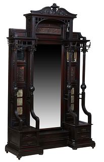 Unusual American Monumental Carved Mahogany Hall Stand, c. 1910, the broken arch crest over an arched crown, with iron coat hooks on the sides, above 