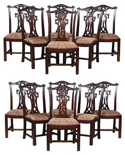Set of Twelve Carved Mahogany Chippendale Style Dining Chairs, 20th c., the arched canted back with a pierced carved scrolled plat, on gadroon edge su