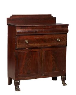 American Classical Carved Mahogany Sideboard, late 19th c., the rectangular top with a splash back over a convex frieze drawer above a deep drawer and