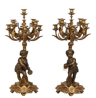 Pair of Gilt and Patinated Brass Louis XVI Style Putto Nine Light Candelabra, 20th c., each with a patinated musical putto standing in front of a flat