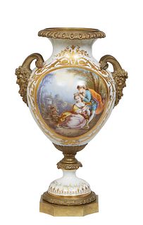 Large Sevres Style Porcelain and Gilt Bronze Mounted Urn, early 20th c., with rams' head bronze handles over a reserve of lovers in a garden, on one s