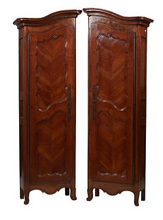 Unusual Matched Pair of French Provincial Louis XV Style Carved Walnut Bonnetieres, late 19th c., the stepped rounded corner crown over double panel d