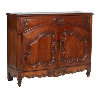 Unusual French Provincial Carved Walnut Sideboard, 19th c., the stepped rounded corner two board lifting top over open storage and double arched field