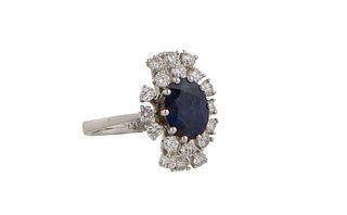 Lady's 18K White Gold Dinner Ring, with an oval 2.38 ct. blue sapphire, within a conforming border of round diamonds, and a top and bottom outer borde