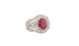 Lady's Platinum Dinner Ring, with an oval 3.07 carat ruby, atop a conforming double concentric border of round diamonds, flanked by pierced tapering d