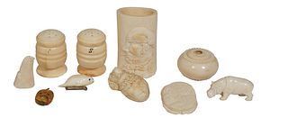Group of Ten Pieces of Ivory, early 20th c., consisting of an ivory seal brooch; an ivory dog's head; and an ivory circular cane handle; and ivory Ori