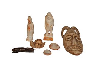 Group of Seven Carved Items, consisting of a carved bone mask; two carved cameos; a standing ivory figure of a church; an ivory figure of a man in a t