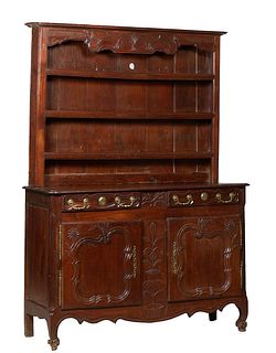 French Louis XV Style Carved Oak Vaisselier, 19th c., the superstructure with a reeded crown over three plate racks, on a rounded corner base with two