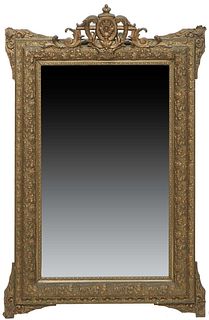 French Louis XV Style Gilt and Gesso Overmantel Mirror, late 19th c., with a pierced arched scroll and floral crest over a wide relief frame with reli