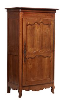 French Louis XV Style Carved Walnut Bonnetiere, 19th c., the stepped canted corner crown over a single double panel door with long iron escutcheons an