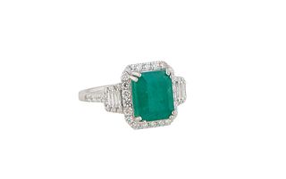 Lady's Platinum Dinner Ring, with a 3.75 ct. emerald atop an octagonal border of small round diamonds, with baguette diamond and round diamond mounted