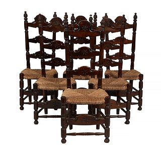Set of Six French Provincial Carved Beech Ladderback Rushseat Side Chairs, 20th c., the tall carved ladder backs on turned supports, to a bowed rush s