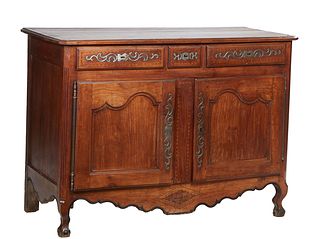 French Provincial Louis Philippe Carved Cherry Sideboard, early 19th c., the stepped edge canted corner top over three frieze drawers with iron escutc
