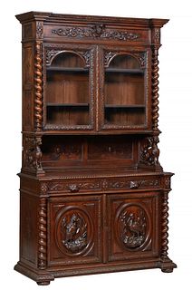 French Henri II Style Carved Oak Buffet a Deux Corps, c. 1880, the stepped breakfront crown over setback glazed double doors flanked by rope twist col