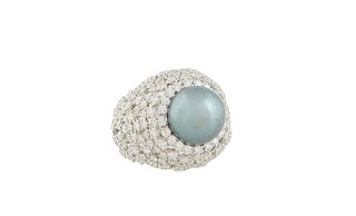 Lady's 18K White Gold Dinner Ring, with an 11mm dark grey South Seas pearl atop a border of round diamonds, flanked by pierced diamond mounted taperin