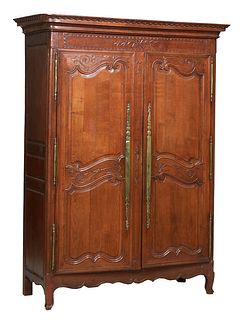 French Provincial Carved Walnut Louis X Style Armoire, early 19th c., the stepped rounded corner crown over double two fielded panel doors with iron f
