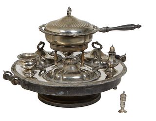 Silverplate Lazy Susan Warming Server, 20th c., with a central covered heated pan, flanked by three covered dishes, a salt shaker, a gravy boat and an