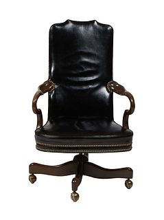 Highback Leather Swivel Armchair, 20th c., the arched highback to curved arms over bowed seat, in black leather with iron tack decoration, H.- 43 1/2,