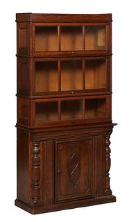 Unusual American Stacking Carved Oak Bookcase, early 20th c., by Macey, with three glass door sections, on a base with a center cupboard flanked by re