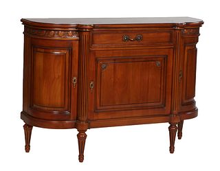 French Louis XVI Style Carved Cherry Sideboard, 20th c., the ogee edge serpentine cookie corner top over a setback frieze drawer above a fielded panel