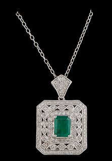 18K White Gold Pendant, of square form with a central 2.85 ct. emerald atop a border of small round diamonds, and a pierced outer octagonal border of 