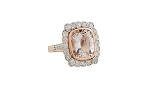 Lady's 14K Rose Gold Dinner Ring, with a cushion cut 5.97 ct. morganite atop a conforming rounded border of round diamonds, the shoulders of the band 