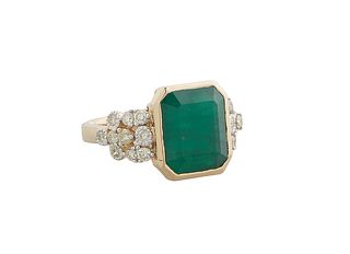 Lady's 14K Yellow Gold Dinner Ring, with a 5.67 carat emerald flanked by diamond mounted lugs, total diamond wt.- .52 cts., size 7, with appraisal.