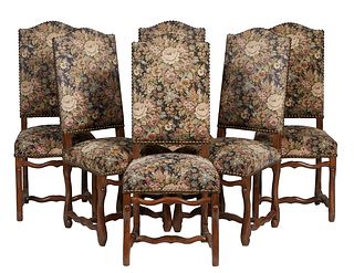 Set of Six French Louis XIII Style Carved Oak Dining Chairs, 20th c., the arched canted high cushioned back over a trapezoidal cushioned seat, on cabr
