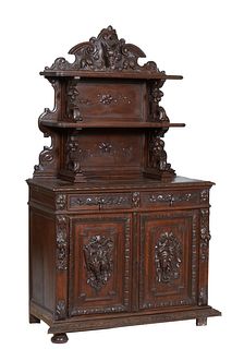 French Provincial Carved Oak Sideboard, 19th c., the arched scrolled top with a relief carved deer atop two graduated stepped shelves, on scrolled nut