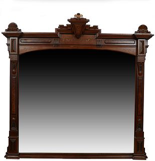 Large American Eastlake Gilt Incised Walnut Overmantle Mirror, c. 1890, the keystone crest flanked by curved shells atop incised carved columns, flank