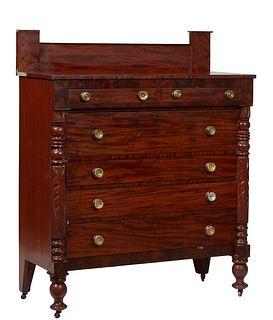 American Classical Carved Mahogany Chest, 19th c., the rectangular top over two frieze drawers, above a deep drawer and three graduated drawers, flank