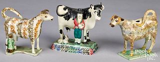 Two pearlware cow creamers and figure